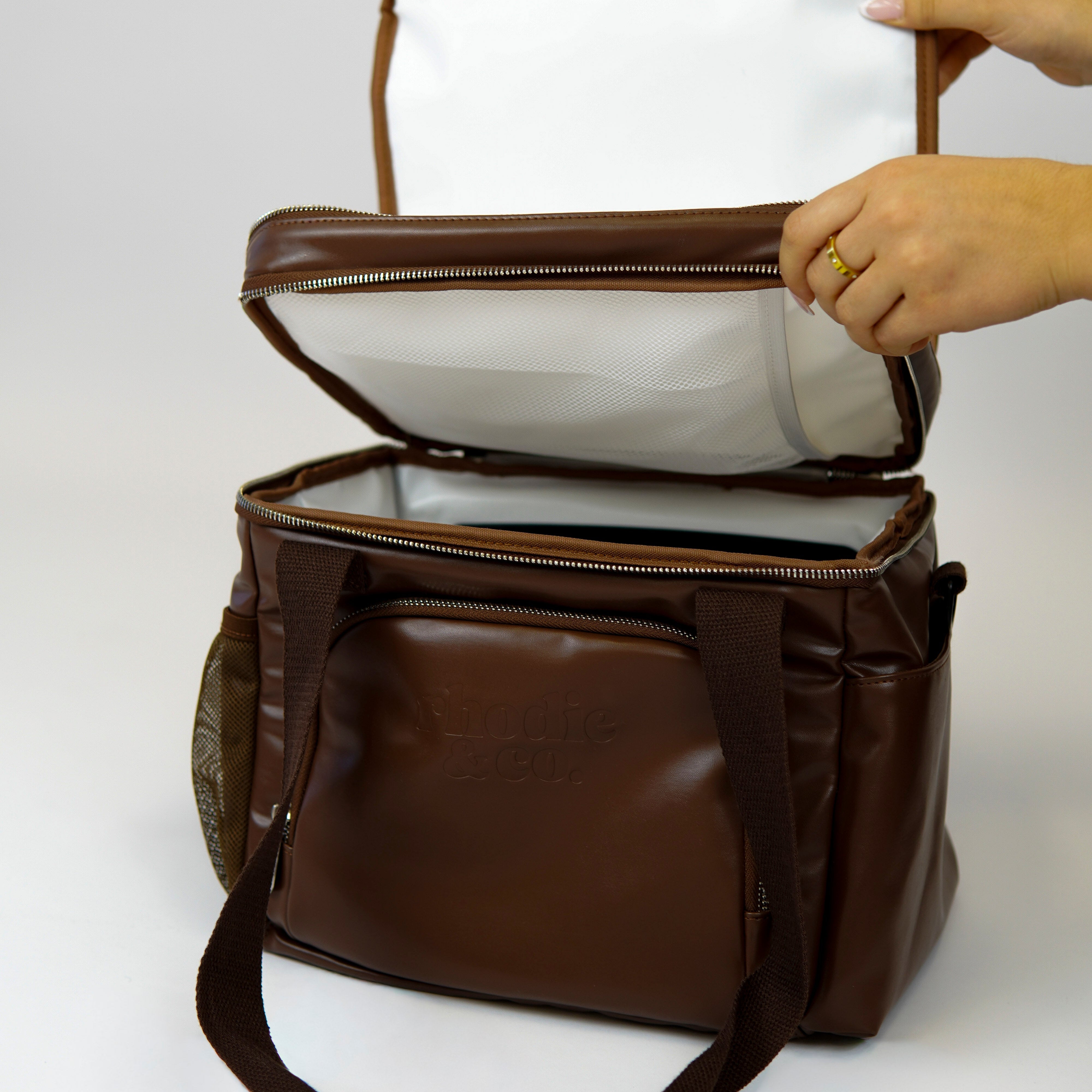 Brown leather bag with a clear top compartment on a white background